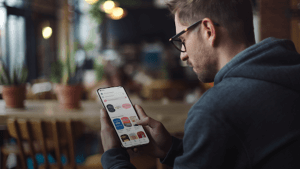 A-person-using-a-cell-phone,-searching-for-the-best-book-apps
